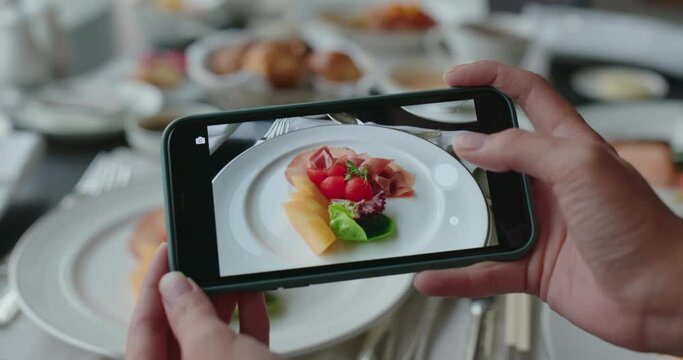 Woman use cellphone to take photo of the dishes