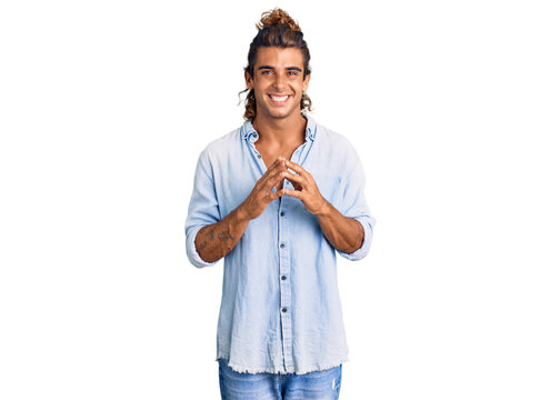 Young hispanic man wearing summer style hands together and fingers crossed smiling relaxed and cheerful. success and optimistic