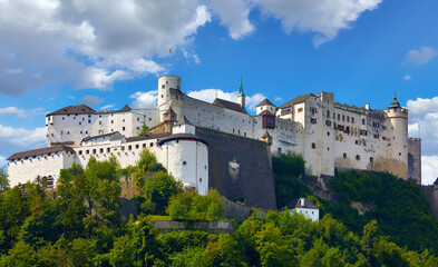 Fortress Salzburg in Austria medieval castle at cliff under the old town. Famous landmark with summer sky with clouds.