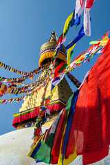 The Bouddhanath Temple in Kathmandu, Nepal. The temple has many colourful prayer flags with 'om...