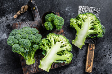 Sliced organic Raw green broccoli cabbage. Black background. Top view