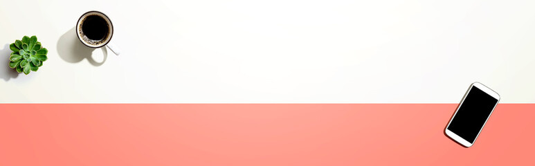 Smartphone with a coffee mug and succulent plant - flat lay