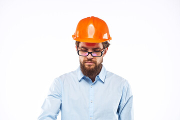 A man in orange paint in glasses documents a manual industry