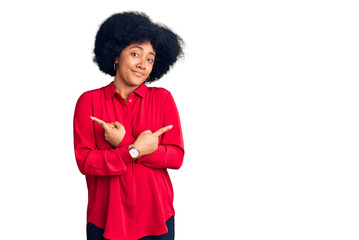 Young african american girl wearing casual clothes pointing to both sides with fingers, different direction disagree