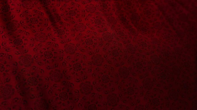 Traditional elegant Asian Double Happiness pattern in red color on waving looped cloth. Concept 3D animation shot for Chinese New Year and festive backgrounds. Luxurious full frame silk texture with c
