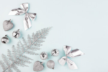 Christmas background, silver Christmas toys on a blue background, top view