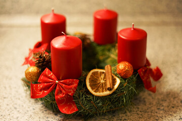 Homemade traditional Christmas advent wreath with natural materials such orange pieces and cinnamon