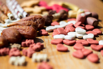 Dog tasty colored biscuits on wooden background 