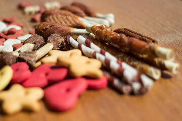 Dog tasty colored biscuits on wooden background 