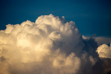 Cumulus clouds in the sunset light. Abstract composition of dramatic sky.