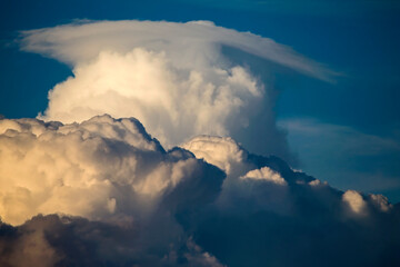 Cumulus clouds in the sunset light. Abstract composition of dramatic sky.