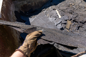 Waste roofing felt in container. Recycling, garbage.