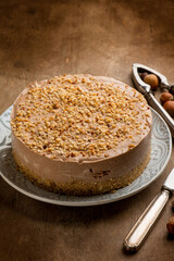 hazelnut cheese cake over wooden background