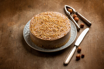 hazelnut cheese cake over wooden background