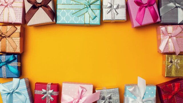 Gift boxes moving on yellow background.Holiday and celebrating concept.Stop motion video.