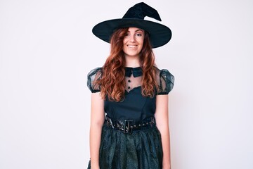 Fototapeta premium Young beautiful woman wearing witch halloween costume with a happy and cool smile on face. lucky person.