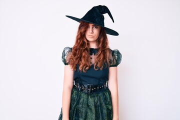Young beautiful woman wearing witch halloween costume skeptic and nervous, frowning upset because of problem. negative person.