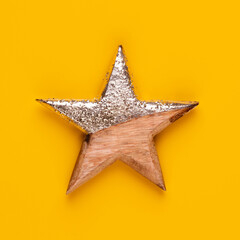 Christmas star decor on yellow colored background.