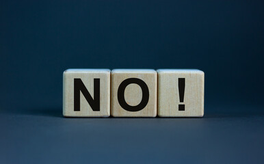 Wood blocks with word 'no' on grey background, copy space. Business concept.