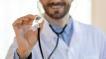 Medical examination. Close up of smiling confident male doctor cardiologist therapist pediatrician...