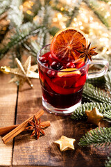 Christmas mulled wine with spices on a wooden rustic table.