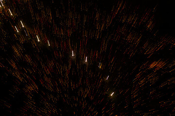 Fototapeta premium Motion abstract lines or particles on black background. candle light, fireworks