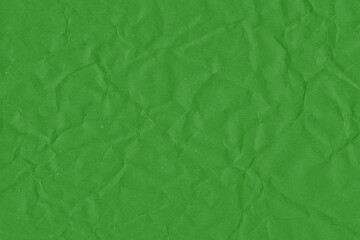Green vintage and old looking crumpled paper background. Retro cardboard texture. Grunge paper for drawing. Ancient book page. Present wrapping.
