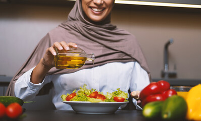 Muslim Woman Cooking In Kitchen Making Salad At Home, Cropped