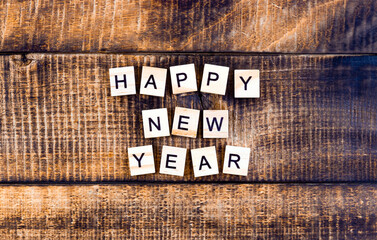 Happy new year lettering on wooden background, festive background concept