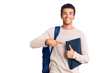 Young african amercian man wearing student backpack holding binder smiling happy pointing with hand and finger - obrazy, fototapety, plakaty