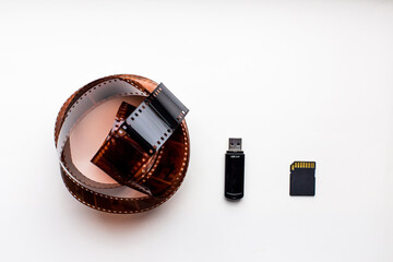 evolution of electronic media isolated on white background. old film usb and sd flash drive