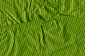 Green vintage and old looking crumpled paper background. Retro cardboard texture. Grunge paper for drawing. Ancient book page. Present wrapping.