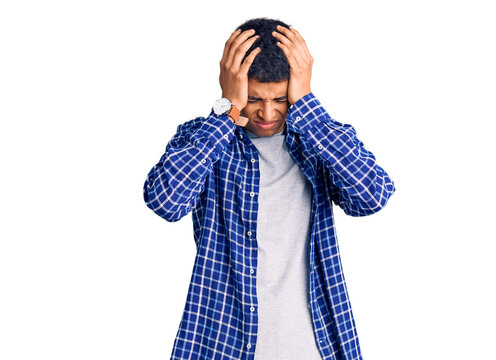 Young african amercian man wearing casual clothes suffering from headache desperate and stressed because pain and migraine. hands on head.