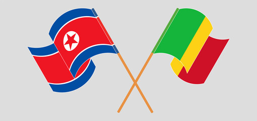 Crossed and waving flags of Mali and North Korea