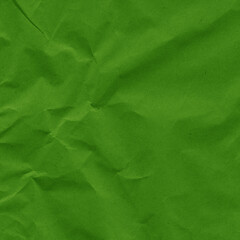 Green vintage and old looking crumpled paper background. Retro cardboard texture. Grunge paper for drawing. Ancient book page. Present wrapping.