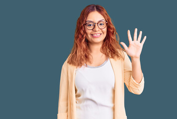 Young latin woman wearing business clothes showing and pointing up with fingers number five while...