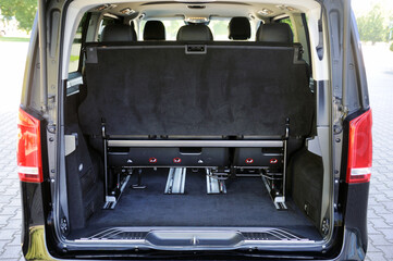 Rear view of the trunk and interior of a business class minibus. Luxury car interior.