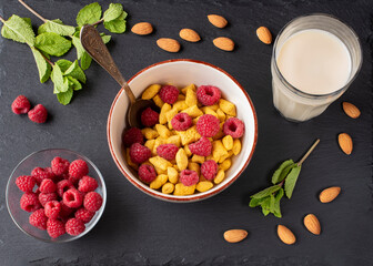 healthy breakfast cereal with raspberry flakes and almond milk