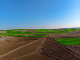 Aerial view to the fertile and arable fields in the spring season ready for sowing