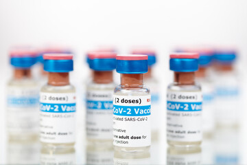 Bottles of new SARS-CoV-2 vaccine on table ready for application
