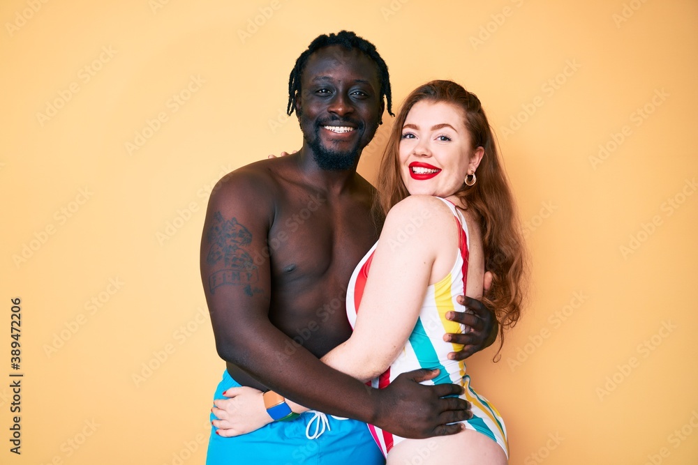 Sticker Interracial couple wearing swimwear with a happy and cool smile on face. lucky person.