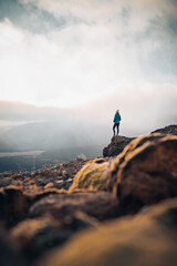 Solo traveler Woman standing on cliff relaxing mountains and clouds aerial view Love and Travel happy emotions Lifestyle concept. Young female traveling active adventure vacations. Landscape Iceland - 389472445