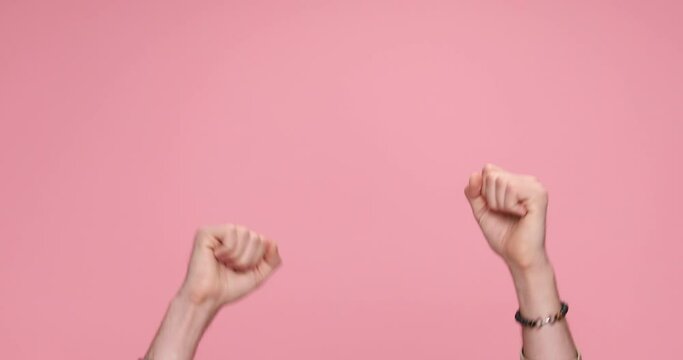 two hands showing palms, giving a thumbs up, celebrating succes, clapping on pink background
