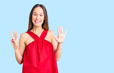 Beautiful brunette young woman wearing casual clothes showing and pointing up with fingers number eight while smiling confident and happy.