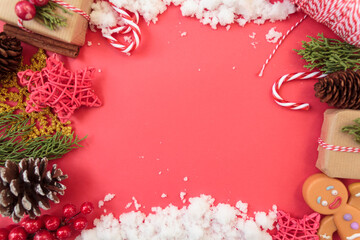Top view of christmas decoration and snow on red background with copy space