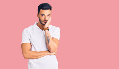 Young handsome hispanic man wearing casual clothes thinking looking tired and bored with depression problems with crossed arms.