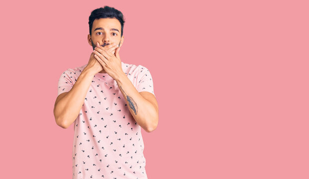 Young handsome hispanic man wearing casual clothes shocked covering mouth with hands for mistake. secret concept.