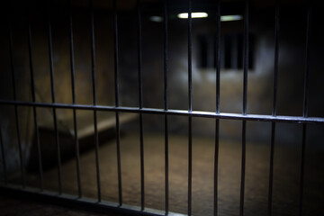 Jail or prison cell. Old grunge prison miniature. Dark prison interior creative decoration. Empty cell. Selective focus Obsolete gray grunge concrete room.