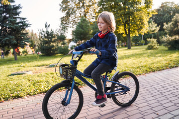 Fototapeta premium Child riding bicycle on a street