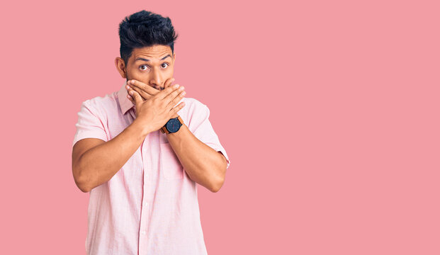 Handsome latin american young man wearing casual summer shirt shocked covering mouth with hands for mistake. secret concept.